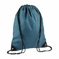 A Bagbase BG010 backpack in teal, featuring black straps and eyelets at the bottom corners.