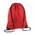 Introducing the BG010, a stylish red drawstring backpack by Bagbase, featuring contrasting black cords and durable reinforced corners.
