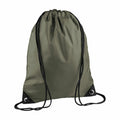 The Bagbase BG010 is displayed against a white background, showcasing its green color with black straps and reinforced corners. The backpack has a minimalist design without any logos or visible designs.