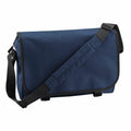The Bagbase BG021 is a navy blue messenger bag featuring a black adjustable shoulder strap and black trim. It comes with a flap cover and is crafted from durable fabric.