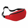 A vibrant red Bagbase BG042 fanny pack featuring a black adjustable strap and a zippered compartment is showcased against a white background.