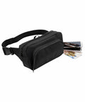A black Bagbase BG053 waist bag with two zippered compartments, containing a smartphone, a pen, euro banknotes, and coins.