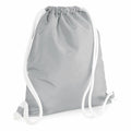 Introducing the BG110 by Bagbase: a light gray drawstring backpack with white strings, boasting a simple and sleek design. The bag is artfully displayed at an angle to accentuate its soft texture and casual style.