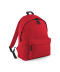 Introducing the BG125 by Bagbase: a practical red backpack featuring black zippers and adjustable shoulder straps. It includes a front pocket and a roomy main compartment, offering a straightforward and functional design.