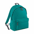 The Bagbase BG125 backpack, shown in teal, features a front zipper pocket and adjustable gray straps. It also includes two zippers on the main compartment for easy access.