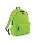 The BG125 by Bagbase is a bright green backpack featuring gray adjustable straps. It includes a front zippered pocket and a spacious main compartment, each with black pull tabs on the zippers. The backpack stands upright against a plain white background.