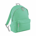 The BG125 backpack by Bagbase features a front pocket, gray zippers, adjustable shoulder straps, and a top handle in a mint green color.