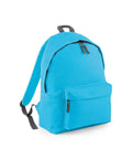 A Bagbase BG125 backpack in a vibrant blue color, featuring a front zipper pocket and adjustable black shoulder straps. Positioned against a plain white background, this bag showcases its simple and functional design.