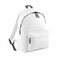 The BG125 by Bagbase is a plain white backpack featuring a front pocket and a black zipper. It includes adjustable straps and a small loop at the top for easy carrying or hanging, embodying a simple and minimalist design.