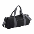 The Bagbase BG140 is a black duffel bag with gray straps, designed with a zippered front pocket and an adjustable shoulder strap.