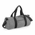 The Bagbase BG140 is a gray cylindrical duffel bag with black straps and a detachable shoulder strap. It includes a front zippered pocket and a main compartment, positioned on a plain white background.