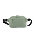 A sage green bag with a front zipped pocket, dual zip pulls on the main compartment, and a black adjustable strap with a side-release buckle, shown against a white background.