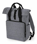 A sleek, gray Bagbase BG18L featuring a top flap secured with a black buckle, padded shoulder straps, and a front zippered compartment. The bag has a minimalist design with a textured fabric appearance and a small side zipper pocket.