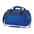 The Bagbase BG200 features a blue design with black straps and a front zippered pocket, displayed against a white background.