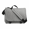 A Bagbase BG218 messenger bag featuring a gray fabric design with a front flap, an adjustable shoulder strap, and black buckles.