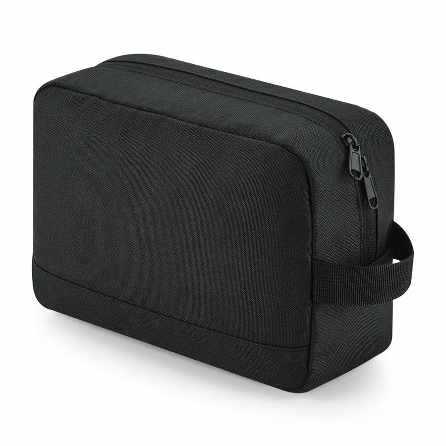 A Bagbase BG277 rectangular toiletry bag in black, featuring a zipper closure and a side handle, positioned at an angle.