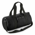 The Bagbase BG284 is a black duffel bag featuring two short handles, a detachable shoulder strap, and three zippered pockets.
