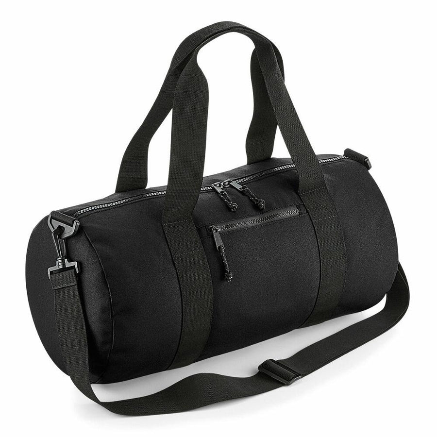 The Bagbase BG284 is a black duffel bag featuring two short handles, a detachable shoulder strap, and three zippered pockets.
