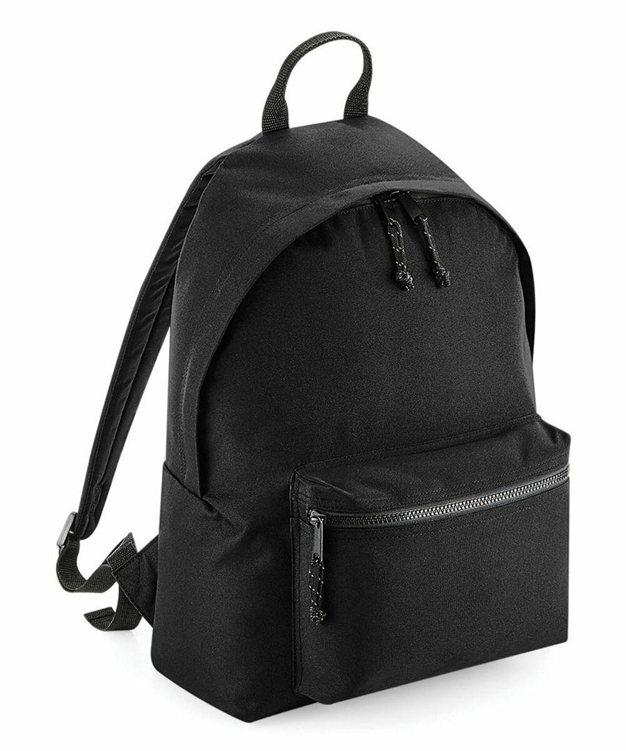 The Bagbase BG285, a black backpack featuring a zippered front pocket and adjustable straps, is displayed on a white background.