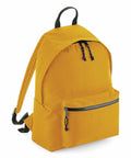 The BG285 by Bagbase is a vibrant yellow backpack featuring black zippers and adjustable straps. It includes a spacious main compartment and a front zippered pocket, with the bag designed to stand upright and equipped with a convenient handle at the top.