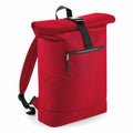 The Bagbase BG286, a red roll-top backpack featuring a black strap and front zipper pocket, is photographed against a plain white background.