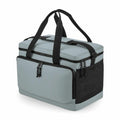 The Bagbase BG290 is a grey soft-sided cooler bag with black straps and zippers, featuring a front zippered pocket and a mesh side pocket.