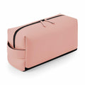 The Bagbase BG337 is a rectangular pink toiletry bag featuring a zipper and a side handle.