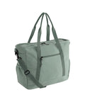 A light sage green tote from Bags with two top handles, a front zip pocket, a main zip compartment, and an adjustable shoulder strap. The design is plain with no visible branding or patterns.