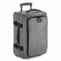 Introducing the Bagbase BG481: a stylish gray suitcase made from fabric, equipped with a telescopic handle and wheels, and featuring a large zipper on the front for easy access.