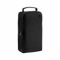 A black rectangular Bagbase BG540 travel bag with a handle and zipper closure standing upright.