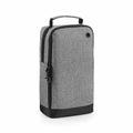 Introducing the Bagbase BG540: a tall shoe bag in gray with a black base, featuring a zipper closure, handle, and a small grommet on the upper right side.