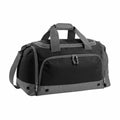 The Bagbase BG544 is a black and gray duffel bag featuring multiple zippered compartments and an adjustable shoulder strap.