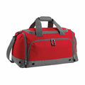 Introducing the Bagbase BG544, a stylish duffel bag in red and gray featuring multiple zippered compartments. It comes with durable gray handles, an adjustable shoulder strap, a reinforced base for added stability, and a convenient mesh side pocket.