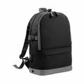 The BG550 backpack by Bagbase, featuring two main compartments, adjustable shoulder straps, and a top carry handle in black and gray, is set against a white background.