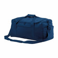 BG561 by Bagbase is a spacious duffel bag in blue, featuring black zippers and a convenient shoulder strap, set against a white backdrop.