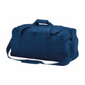 The Bagbase BG562 is a spacious duffel bag in dark blue, featuring a shoulder strap and two handles.