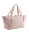 A Bags tote in light pink, featuring two handles, an adjustable shoulder strap, a front zip pocket, and a top zip fastening, shown against a plain white background.