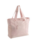The Bags tote is light pink with two shoulder straps, an exterior zip pocket, and a mesh side pocket, displayed against a plain white background.