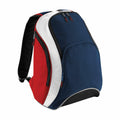 The BG571 by Bagbase is a sporty backpack that showcases a stylish combination of navy blue, red, and white panels. It features multiple zippered compartments and adjustable black shoulder straps. Its sleek and modern design makes it perfect for casual outings or school use.