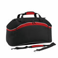 Introducing the Bagbase BG572: a sleek sports duffel bag in black and red, featuring a curved top, dual handles, a detachable shoulder strap, and a convenient front zipper pocket.