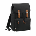 Introducing the Bagbase BG613: a sleek black backpack with brown leather straps and zipper pulls, featuring a main compartment with a flap cover and a front zip pocket.