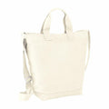 The Bagbase BG673 tote bag in beige, featuring handles and an adjustable shoulder strap, is displayed against a white background.