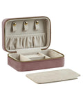 A small, rectangular pink Bags jewellery box with a gold zip, beige interior, three hooks, elasticated pocket, divided compartments, and removable section cover is shown open with its lid and cover next to it.