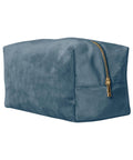 A teal rectangular suede bag called "Bags" with a gold zip, displayed against a white background.