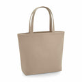 The Bagbase tote bag, model BG721, is displayed against a plain white background. It's a beige bag with two handles and features a simple, minimalist design, suggesting it's made from sturdy fabric.