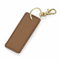 The Bagbase BG744 is a rectangular brown leather keychain featuring a textured finish, elegantly attached to a gold keyring and clasp.
