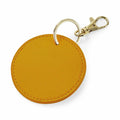 The BG745 keychain by Bagbase features a round yellow leather design with a gold metal ring and lobster clasp.