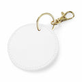 The BG745 by Bagbase is a white, round keychain featuring a gold ring and a lobster clasp. Its textured surface remains plain without any visible design or logo.