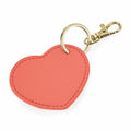 Introducing the Bagbase BG746: a heart-shaped keychain in coral color, featuring a gold keyring and clasp.