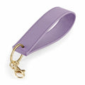 The BG747 by Bagbase is a keychain featuring a purple, textured leather loop with gold-tone hardware, complemented by a round key ring and a lobster clasp.